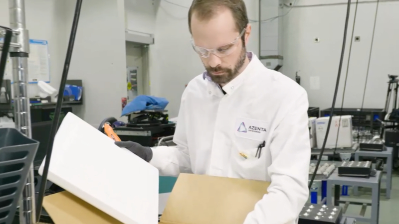 Lab staff inspecting boxes