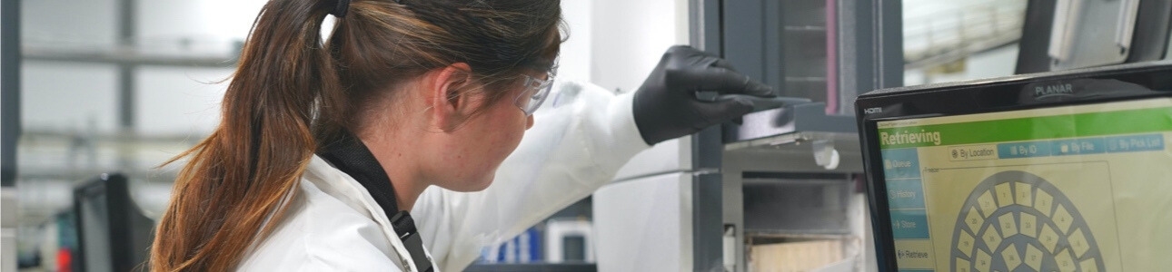 Lab technician inspecting CyoArc cryogenic storage system