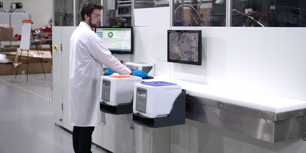 Technician next to a storage unit with CryoPods and software