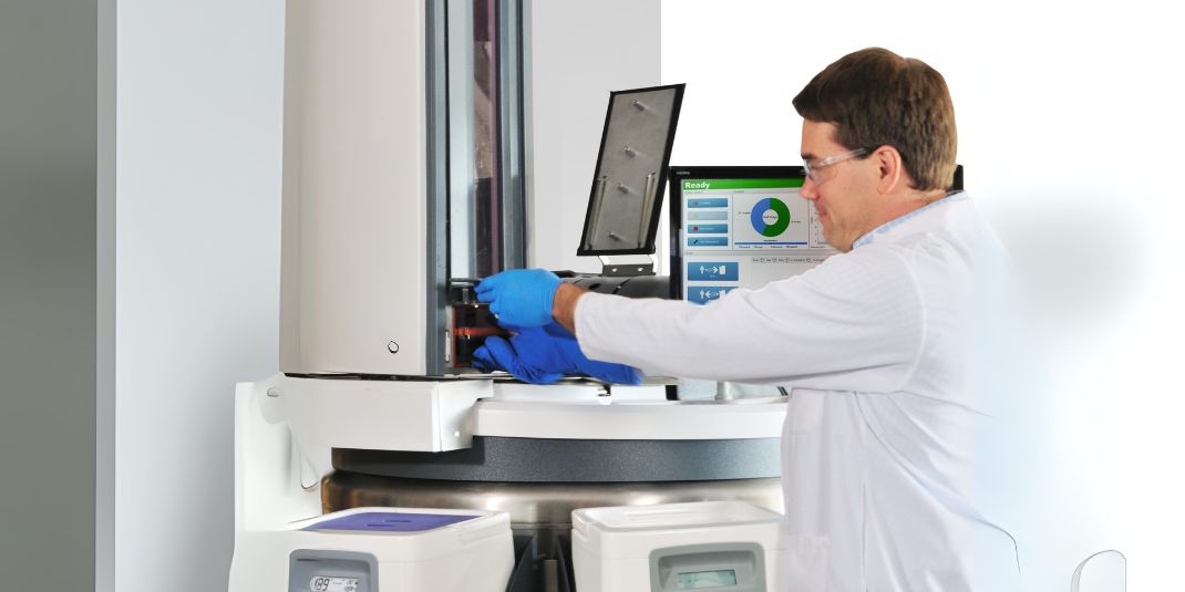 Lab technician pulling labware form CryoArc unit