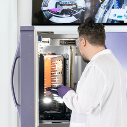 Lab technician inspecting automated sample storage system