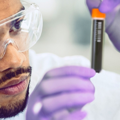 Lab technician inspecting a sample storage tube