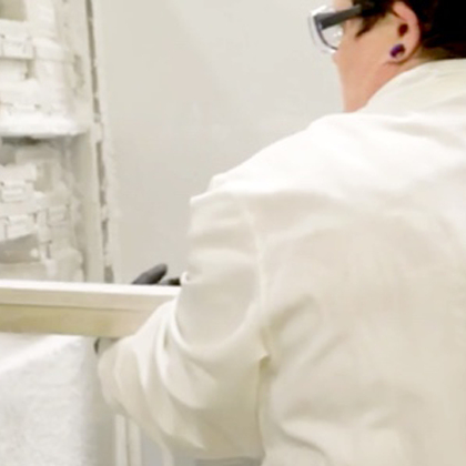 Lab technician loading cryo rack in freezer