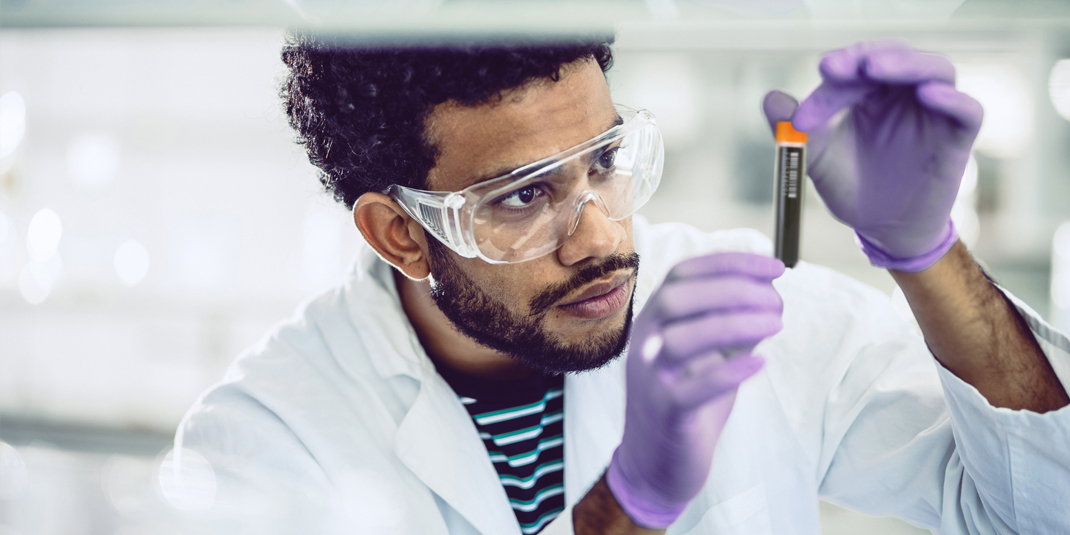 Lab technician inspecting FluidX tube